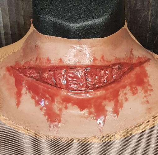 Thick slit around throat with dripping blood silicone prosthetic